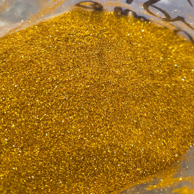 Close-up of gold glitter with a clear background